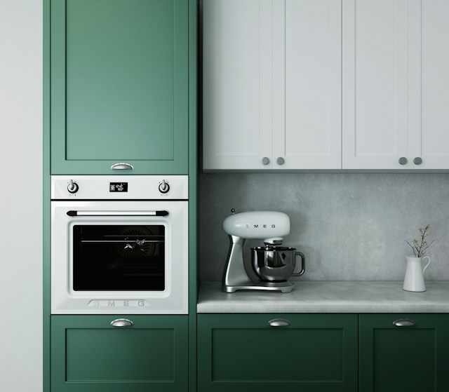 A kitchen with green cabinets.