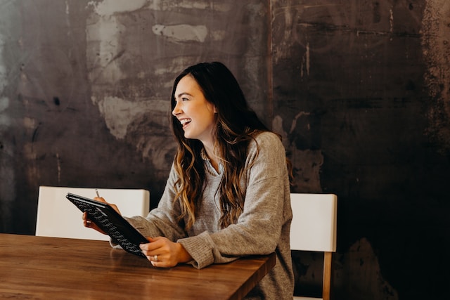 Smiling person looking at a tablet