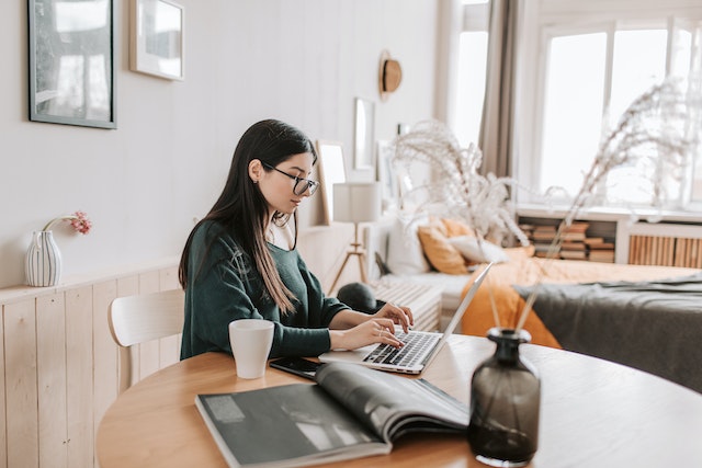 Person researching real estate on their laptop at a table