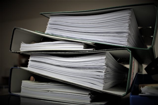 Large binders filled with papers.