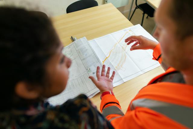 A contractor and homeowner discussing plans.