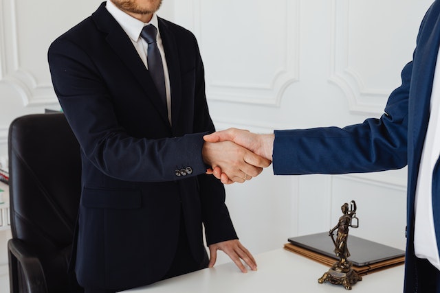 two people in suits shaking hands